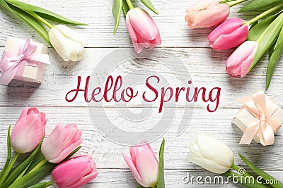 Flat lay composition of beautiful flowers and text Hello Spring Stock Photo