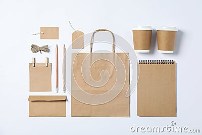 Flat lay composition with blank stationery, paper cups and bag on white background Stock Photo