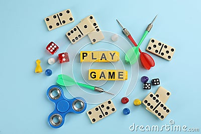 Flat lay composition of blocks with words Play Game on light blue background Stock Photo