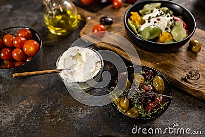 Flat lay composition of bowl of dumplings, jar of sour cream on wooden board Stock Photo