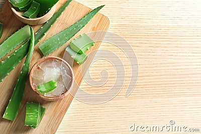 Flat lay composition with bowl of peeled aloe vera, green leaves and space for text Stock Photo