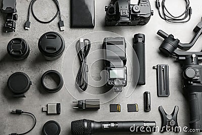 Flat lay composition with camera and video production equipment on light grey stone background Stock Photo