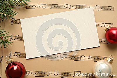 Flat lay composition with Christmas decorations and blank card on music sheets Stock Photo