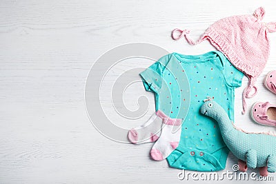 Flat lay composition with cute clothes and space for text on white wooden background Stock Photo