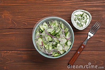 Flat lay composition with delicious fresh cucumber onion salad in bowl served Stock Photo