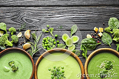 Flat lay composition with different fresh vegetable detox soups made of green peas, broccoli and spinach in dishes on table. Stock Photo