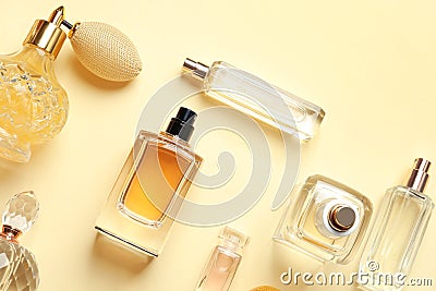 Flat lay composition with different perfume bottles on yellow background Stock Photo