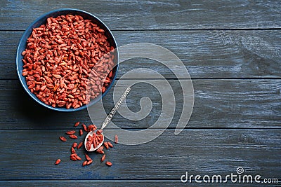 Flat lay composition with dried goji berries on blue wooden table. Healthy superfood Stock Photo