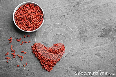 Flat lay composition with dried goji berries on grey table. Healthy superfood Stock Photo