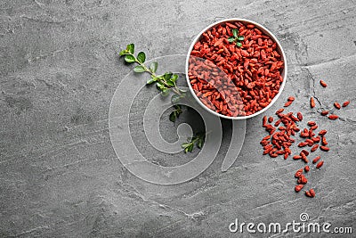 Flat lay composition with dried goji berries on grey table. Healthy superfood Stock Photo