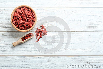 Flat lay composition with dried goji berries on white wooden table. Healthy superfood Stock Photo