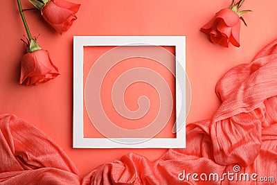 Flat lay composition with frame, roses and fabric on coral background. Stock Photo