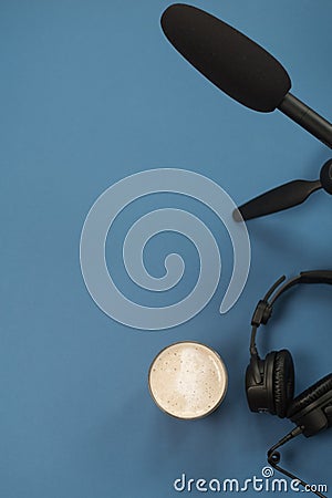 Flat lay composition with Headphones, microphone and coffee on a blue background. Podcast or webinar concept Stock Photo