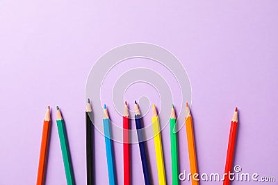 Flat lay composition with multicolor pencils on violet background Stock Photo