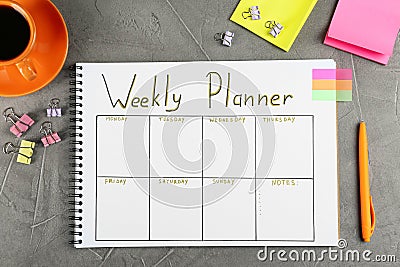 Flat lay composition of notebook with weekly plan on grey table Stock Photo