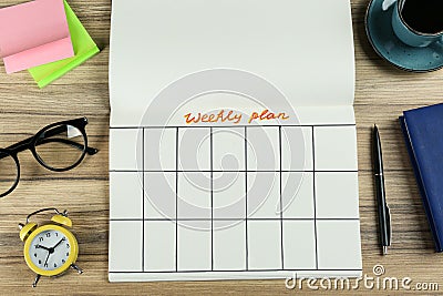 Flat lay composition of notebook with weekly plan on wooden table Stock Photo