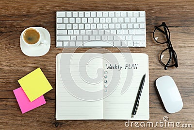 Flat lay composition of notebook with weekly plan on wooden table Stock Photo