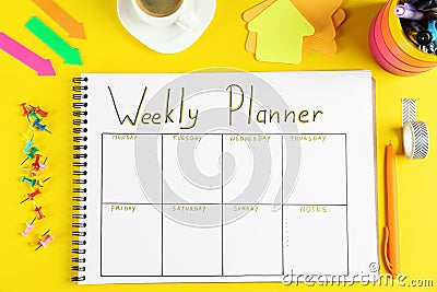 Flat lay composition of notebook with weekly plan on yellow background Stock Photo