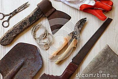 Flat lay composition with old secateurs and other gardening tools on white wooden table Stock Photo