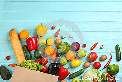 Flat lay composition with overturned paper and groceries on blue wooden background Stock Photo