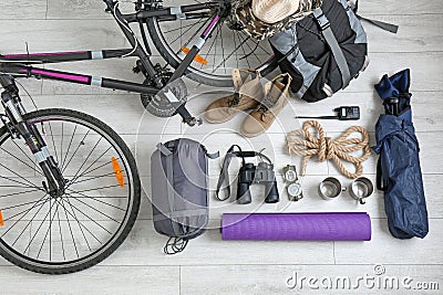 Flat lay composition with sleeping bag, bicycle and camping equipment Stock Photo