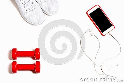 Flat lay composition with sneakers, headphones, mobile phone and red dumbbells on white background. Stock Photo