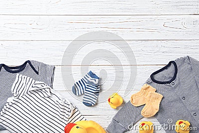 Flat lay composition with stylish baby clothes and toys on wooden background Stock Photo