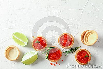 Flat lay composition with tartlets with caviar, rosemary and limes Stock Photo
