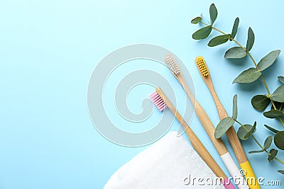 Flat lay composition with toothbrushes made of bamboo on blue background. Space for text Stock Photo