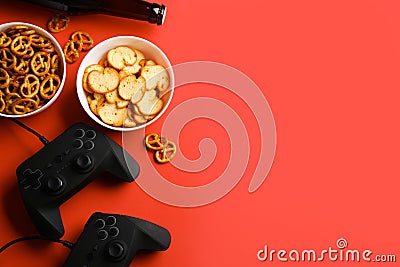Flat lay composition with video game controllers, snacks and space for text Stock Photo