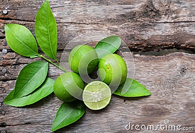 Flat lay cut whole limes wooden table .copy space Stock Photo