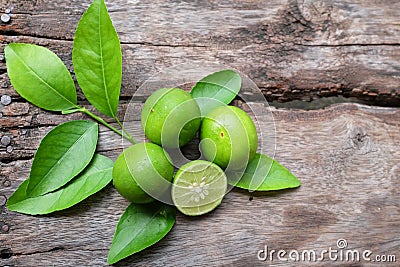 Flat lay cut whole limes wooden table .copy space Stock Photo