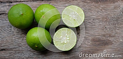 Flat lay cut whole limes wooden table .copy space Stock Photo