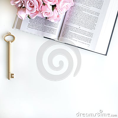 Flat lay with different accessories; flower bouquet, pink roses, open book, Bible Stock Photo