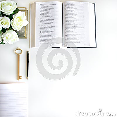 Flat lay with different accessories; flower bouquet, pink roses, open book, Bible Stock Photo