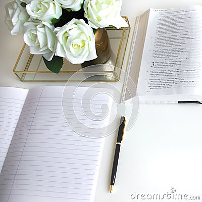 Flat lay with different accessories; flower bouquet, white roses, open book, Bible Stock Photo