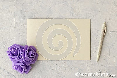 Flat lay fashion mockup: textured card, purple rosses and dip pen on white background Stock Photo