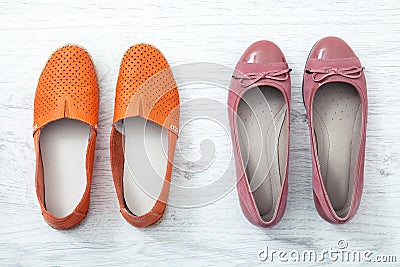 Flat lay fashion set: colored slippers shoes on white wooden background. Top view. Stock Photo