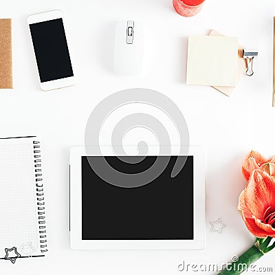 Flat lay feminine workspace tablet notebook smartphone flowers personal accessories Stock Photo