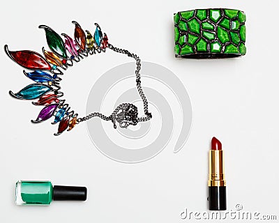 Flat lay feminini accessories collage with glasses, lipstick, bracelet, necklace on white background. Stock Photo