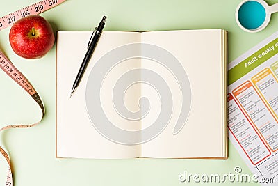 Flat lay of a food diary and tape measure Stock Photo