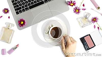 Flat lay with laptop, cup of tea, bottles of perfume, woman make u[ products and flowers Stock Photo