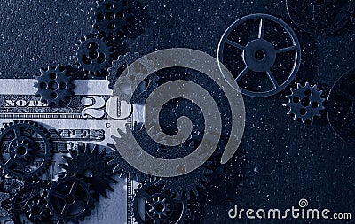 Flat-lay mechanical gears on a twenty dollar bill Stock Photo