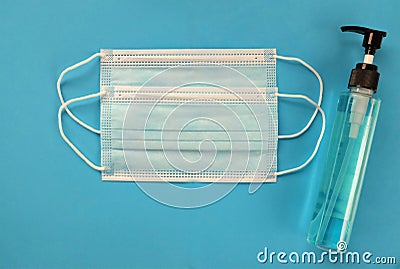 Flat lay Medical mask and alcohal gel for protecting infection during Coronavirus on blue background Stock Photo