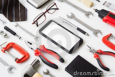 Flat lay mock up Smart Phone With man`s accressories and essential construction tools worker on white background. Mockup mobile Stock Photo