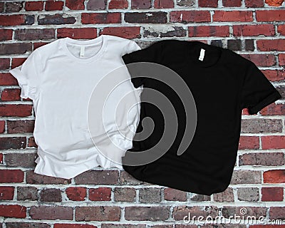 Flat lay mockup of white tshirt and black tshirt on brick background Stock Photo