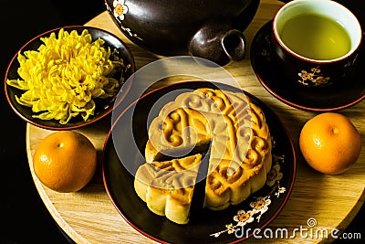 Flat lay modern stylised mid autumn festival food on black background. Stock Photo