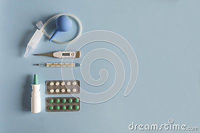 Flat lay nasal wash instrument, electronic and mercury thermometer, nasal drops and spray, cold and flu pills.Copy space, Stock Photo