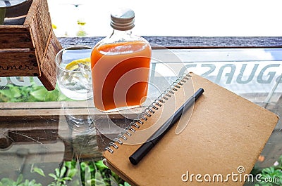 Flat lay of notebook pen and beverage in restaurant Stock Photo