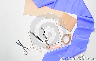 Flat lay from a notepad, pens, scissors, perfume bottle Stock Photo